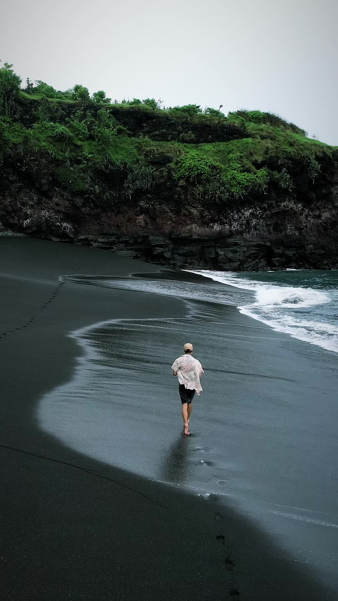 Running in the rain on a black sand beach 🏖️  📍Black Sand Beach, Karangasem Regency, Bali #dronevideos #dronenature #tropicalparadise #running#baliparadise #indonesia #bali #blacksandbeach